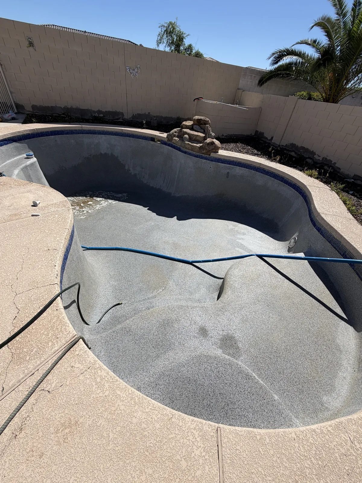 Pool technician inspecting equipment during service call