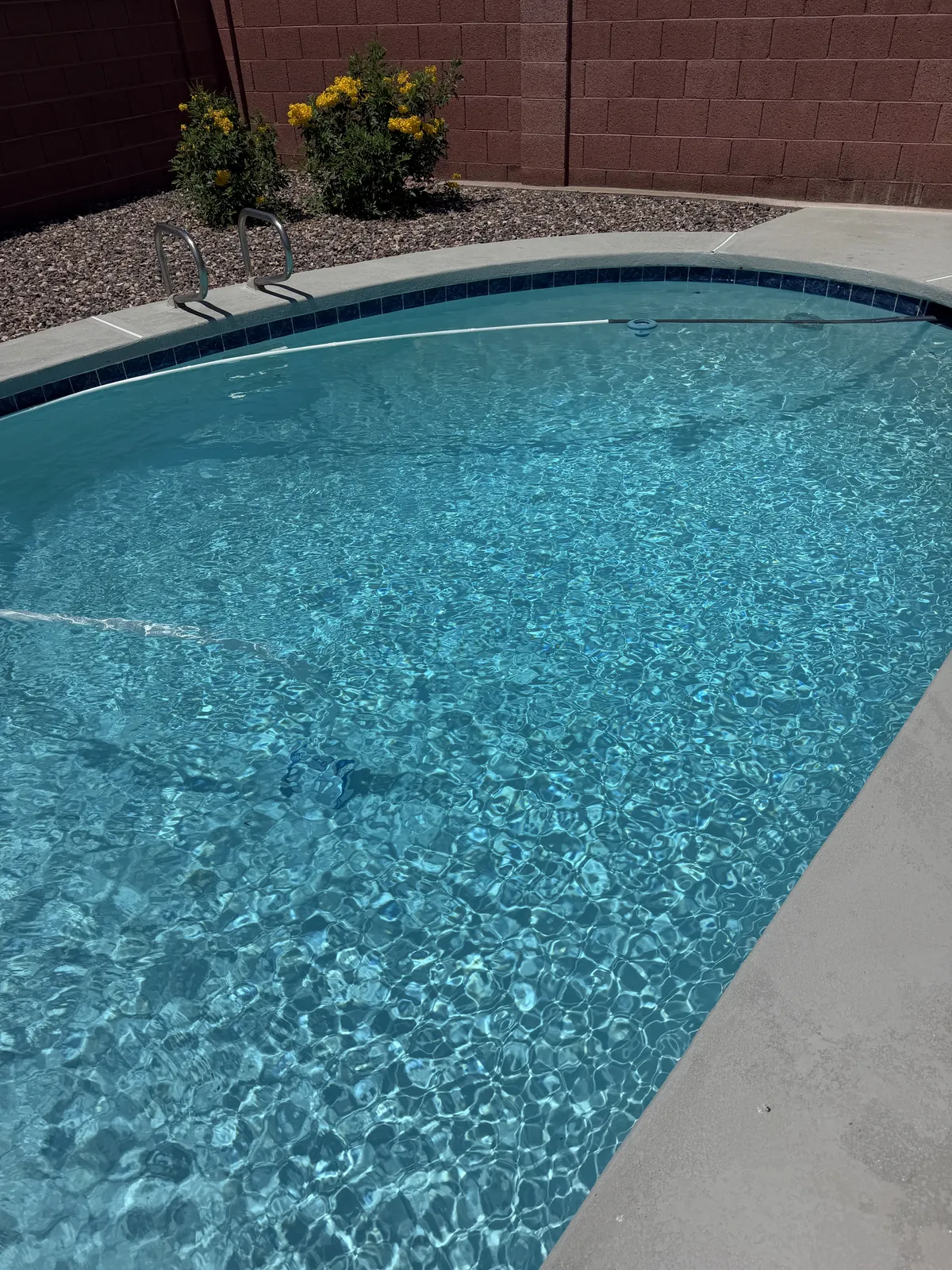 Weekly pool cleaning service with clear blue pool water